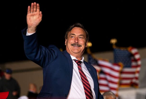 PHOTO: MyPillow CEO Mike Lindell waves as he is introduced while former U.S. President Donald Trump speaks during a campaign event at Sioux Gateway Airport, Nov. 3, 2022, in Sioux City, Iowa. (Stephen Maturen/Getty Images)