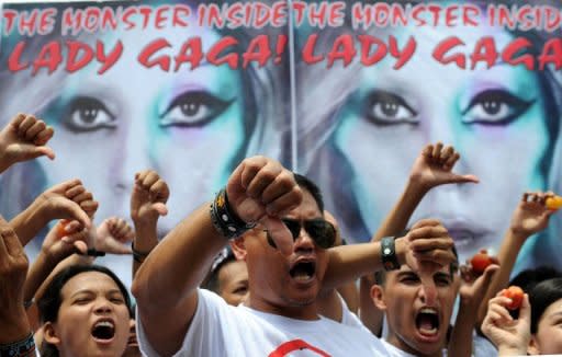 Members of Biblemode Youth Philippines protest in front of posters promoting Lady Gaga in Manila on May 19. Gaga is set to rock the Philippines later Monday amid more planned street protests and with censors in the house on orders to report any hint of blasphemy, devil worship, nudity or lewd conduct