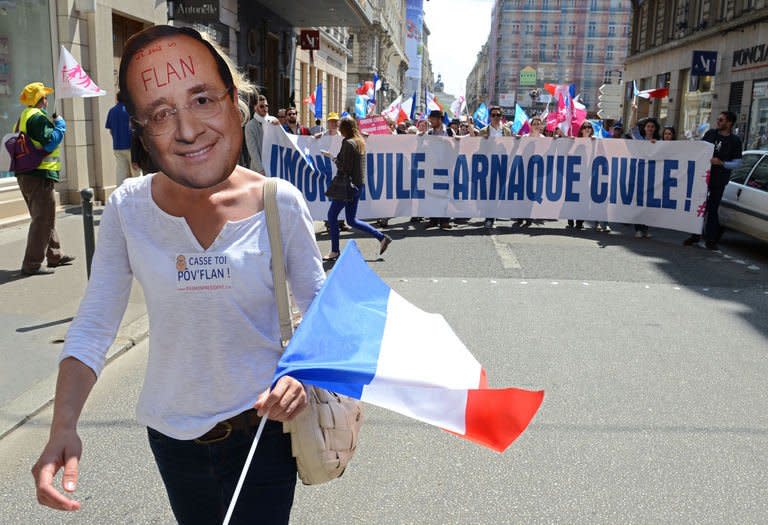 A person wears a mask representing French president François Hollande during a demonstration called by the anti-gay marriage movement "La Manif Pour Tous" (Demonstration for all !) on May 5, 2013 in Lyon, central eastern France
