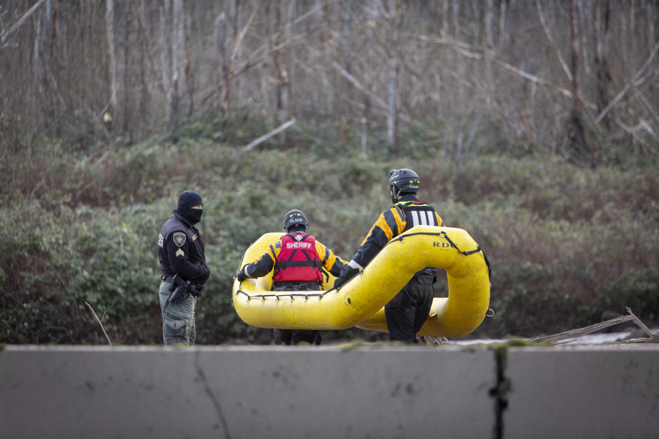 FILE - In this Thursday, Jan. 14, 2021 file photo, Search and rescue crews continue to look for a missing woman whose car was swept away by a mudslide Wednesday in the Dodson area of the Columbia River Gorge, in Oregon. Sheriff’s deputies and firefighters on Saturday, Jan. 23, 2021 recovered the body of an Oregon woman whose vehicle was swept away in a deep mudslide during a winter storm last week. Jennifer Camus Moore, a registered nurse from Warrendale, Oregon, was driving in the Columbia River Gorge early Wednesday when her SUV was buried under about 15 feet of mud, rock and trees. (Brooke Herbert/The Oregonian via AP)