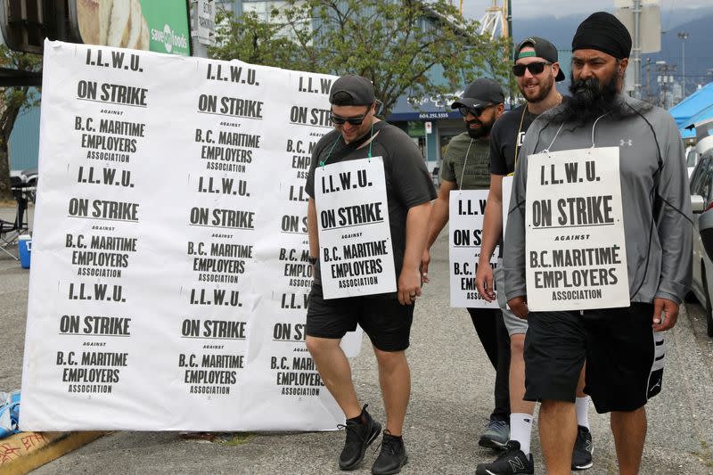 FILE PHOTO: Striking longshoremen walk picket line in Vancouver