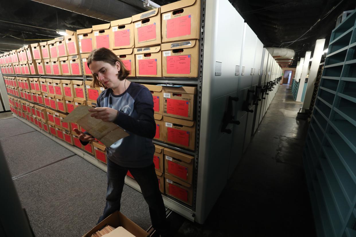 Muskingum County Records Supervisor Lucretia Frame looks for some of the oldest records still in existence at the Records Center on Fifth Street in Zanesville.