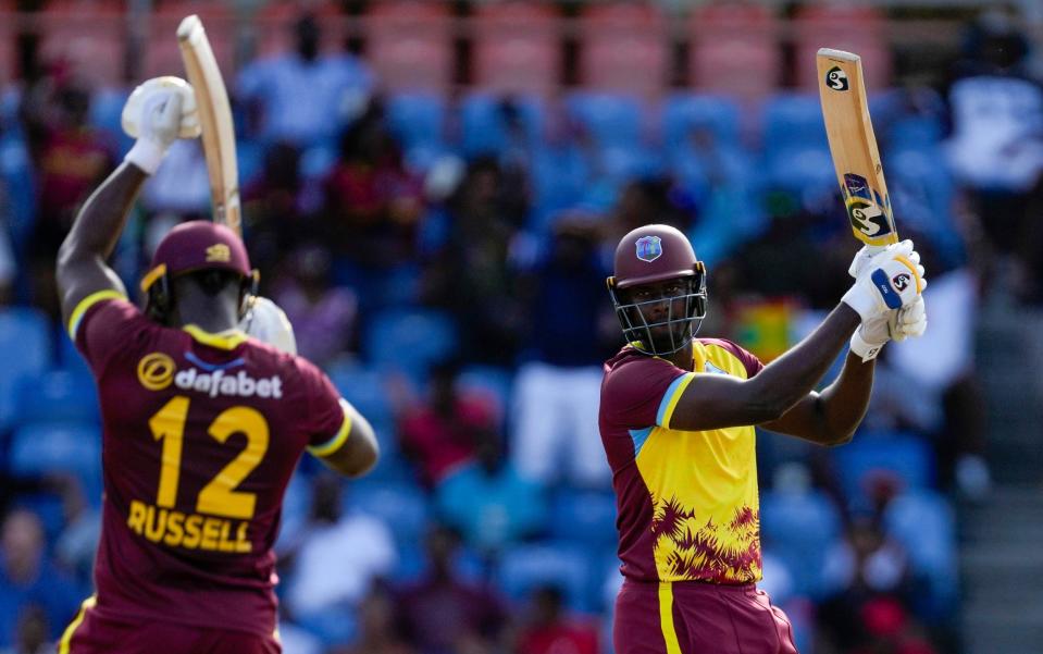 Andre Russell applauds after Jason Holder hits the last ball of the West Indies innings for six