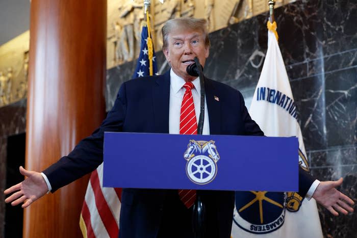 Donald Trump speaking at a podium with "TEAMSTERS" logo, American and Teamsters flags in the background