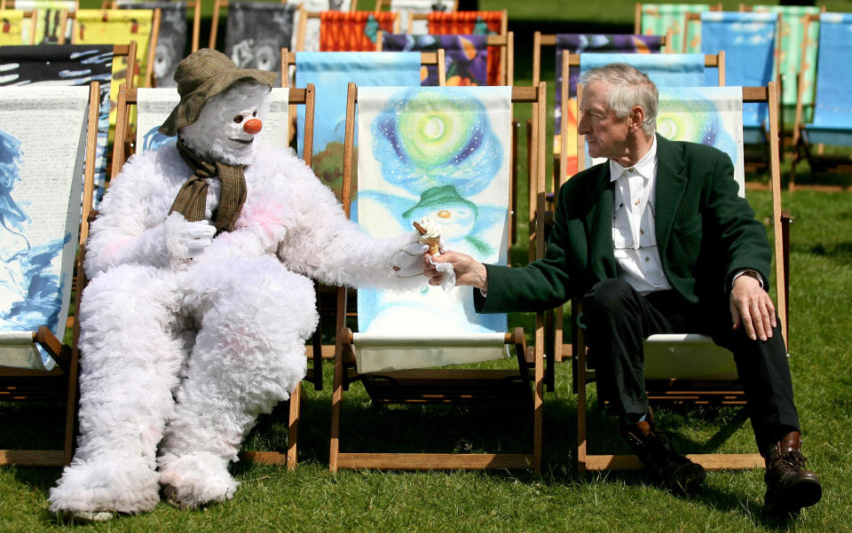 A snowman hands an ice cream to Raymond Briggs in a deckchair designed by the author in Hyde Park, London.   (Photo by Anthony Devlin - PA Images/PA Images via Getty Images)