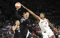 Las Vegas Aces forward Alysha Clark (7) grabs a rebound ahead of Phoenix Mercury forward Natasha Mack (4) during the first half of an WNBA basketball game Tuesday, May 21, 2024, in Las Vegas. (Steve Marcus/Las Vegas Sun via AP)