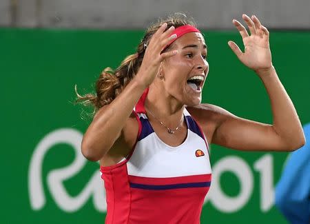 2016 Rio Olympics - Tennis - Final - Women's Singles Gold Medal Match - Olympic Tennis Centre - Rio de Janeiro, Brazil - 13/08/2016. Monica Puig (PUR) of Puerto Rico celebrates after winning match against Angelique Kerber (GER) of Germany. REUTERS/Toby Melville