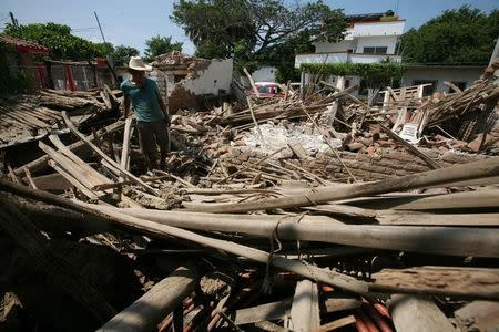 A man stands amidst the remains of a house after an earthquake struck the southern coast of Mexico late on Thursday, in Union Hidalgo, Mexico September 9, 2017. REUTERS/Jorge Luis Plata