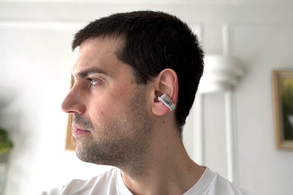 man wearing earbuds that wrap around lobe