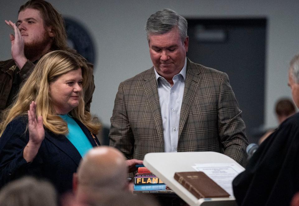 Incumbant board member Karen Smith, left, gets sworn-in with her son Alex, left, and husband Peter Smith, right, at her side at the Central Bucks School District Board re-org in Doylestown on Monday, Dec. 4, 2023. [Daniella Heminghaus | Bucks County Courier Times]