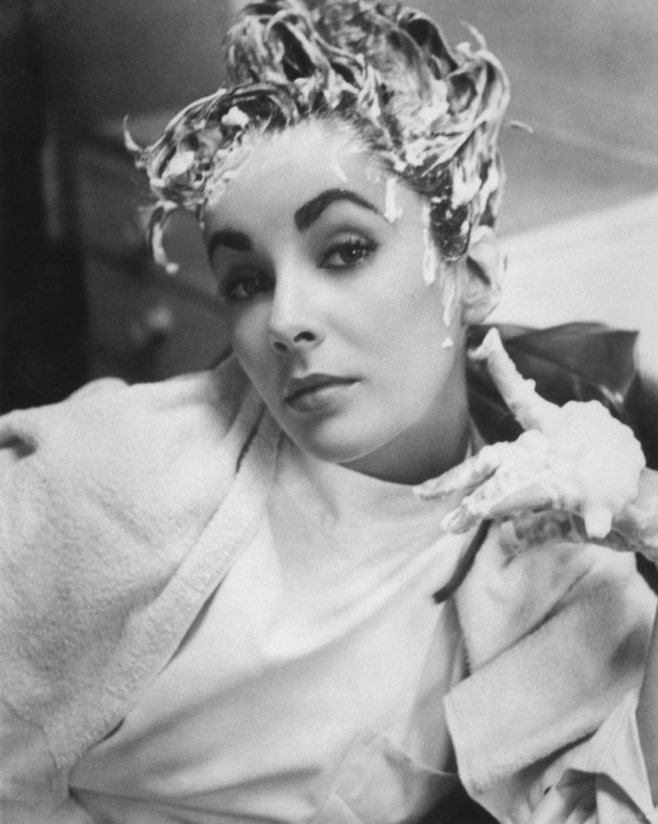 <p>Elizabeth shows off her silly side by posing for a goofy photo while getting her hair washed.</p>