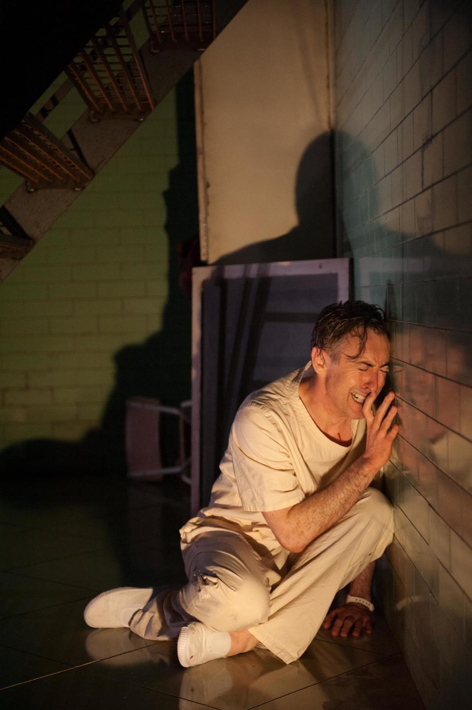 This undated theater image released by National Theatre of Scotland shows Alan Cumming in "Macbeth." In the play, Cumming appears as a patient in a white-tiled mental hospital for whom the plot of "Macbeth is sort of a schizophrenic nightmare. The production, which started in Scotland in mid-June before coming to New York for the next few days as part of the Lincoln Center Festival. (AP Photo/National Theatre of Scotland, Manuel Harlan)