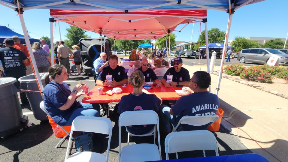 Members of the Amarillo Fire Department enjoy lunch Friday at the 17th annual Boots and Badges Blood Drive at the Coffee Memorial Blood Center in Amarillo.