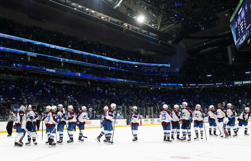 The Colorado Avalanche gather to celebrate a 4-1 win over the Seattle Kraken after an NHL hockey game Tuesday, Oct. 17, 2023, in Seattle. (AP Photo/Lindsey Wasson)