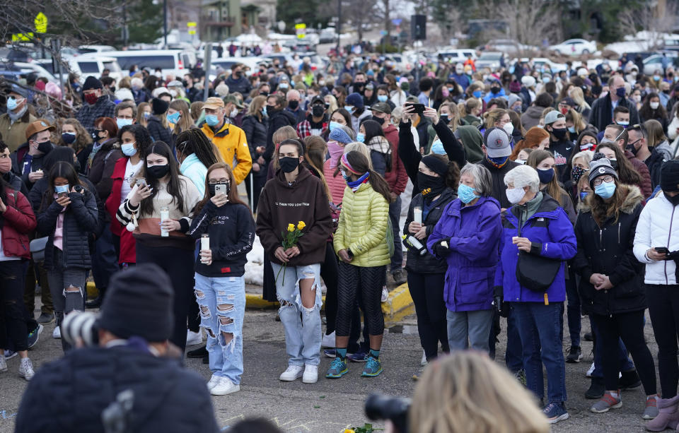 Mourners gather at a vigil for the 10 victims of the Monday massacre at a King Soopers grocery store late Thursday, March 25, 2021, at Fairview High School in Boulder, Colo. (AP Photo/David Zalubowski)