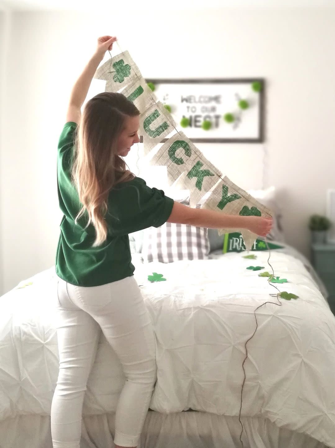 girl holding up a st patrick's day burlap banner that reads 