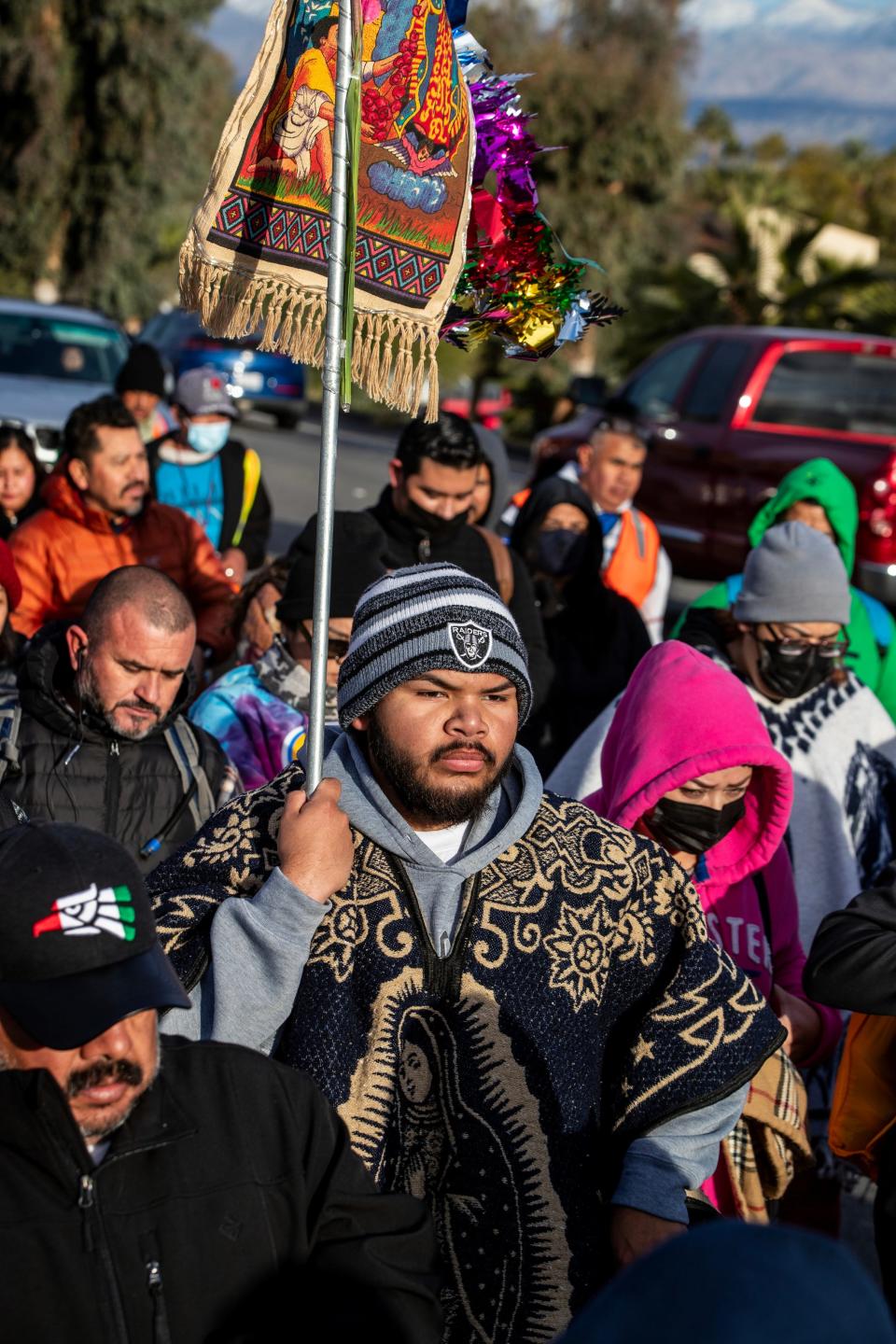 Fernando Ortiz walks along Highway 111 in Palm Springs with fellow Catholics on Monday during the annual 32-mile Our Lady of Guadalupe pilgrimage.