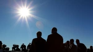 The sun blazes over a crowd in Australia.