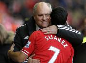 Fulham manager Martin Jol embraces Liverpool player Luis Suarez before their English Premier League soccer match at Anfield in Liverpool, northern England November 9, 2013.