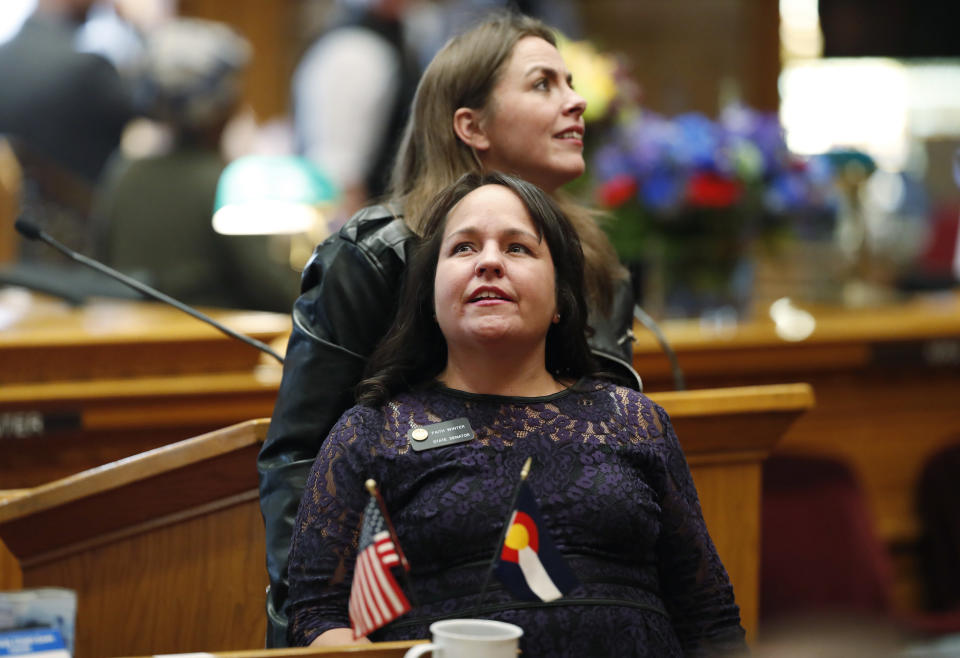 Colorado Sens. Faith Winter (D-Thornton) and Kerry Donovan (D-Vail) look into the gallery as lawmakers convene for a new Senate session in the State Capitol in Denver on Friday, Jan. 4, 2019. (Photo: David Zalubowski/AP Photo)