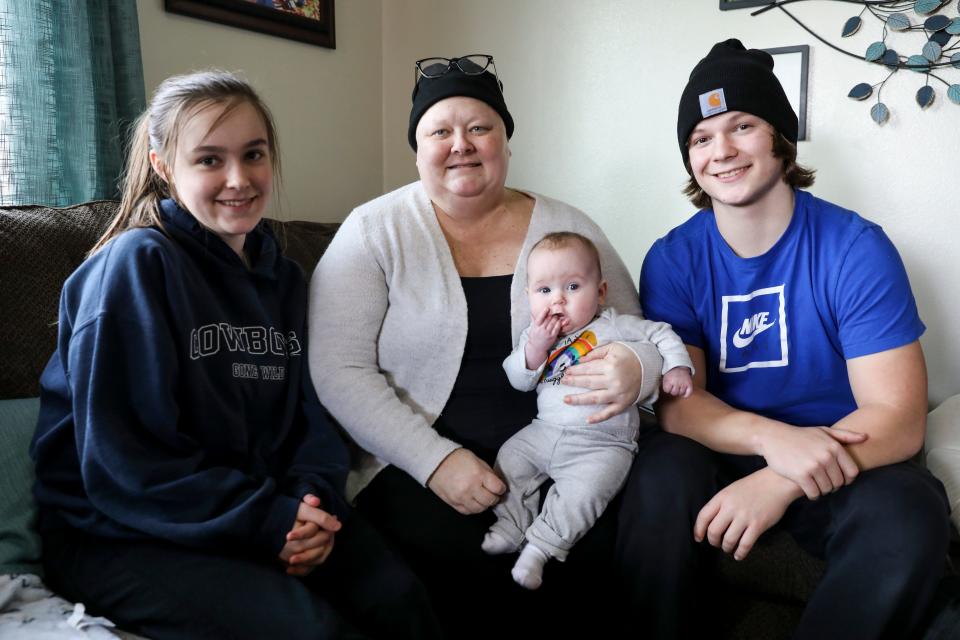 Lisa Painter with her kids, Hannah and Jaden, and her grandchild Adrianna at their home in Salem.