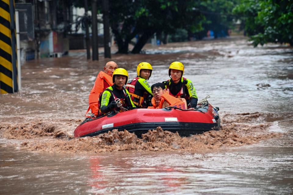 Rescuers evacuate flood trapped residents following a flood in Wanzhou District, in southwest China (Xinhua)