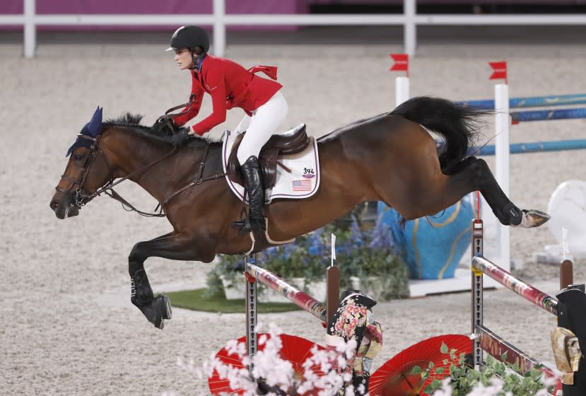TOKYO, - AUGUST 03: Jessica Springsteen riding her horse Don Juan Van De Donkhoeve clears a gate during the Jumping Individual Qualifier event at Equestrian Park during the Tokyo Olympics. This is during the Tokyo Olympics.Tokyo Olympics on Tuesday, Aug. 3, 2021 in Tokyo, {stmens}. (Gary Ambrose / For the Times)