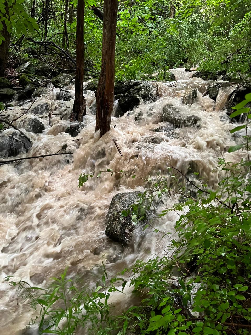The Sucker Brook roars in Williston on July 16, 2023 following days of excessive rain and flooding that devastated may Vermont homes and businesses. This part of the Sucker Brook is typically a docile, trickling stream close to Williston area hiking.