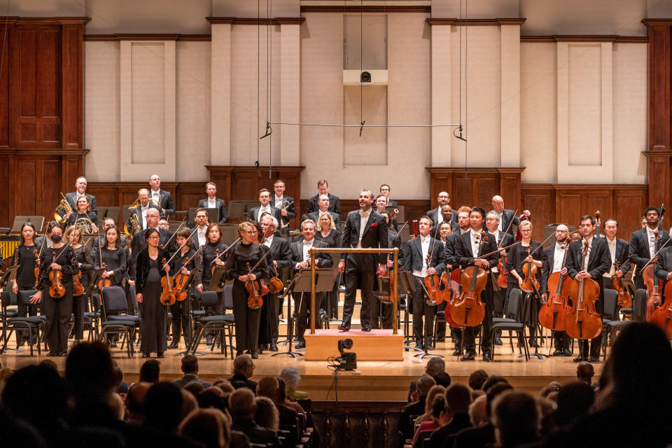 The Detroit Symphony Orchestra, conducted by Jader Bignamini, center, greets a full Orchestra Hall on May 6, 2023.