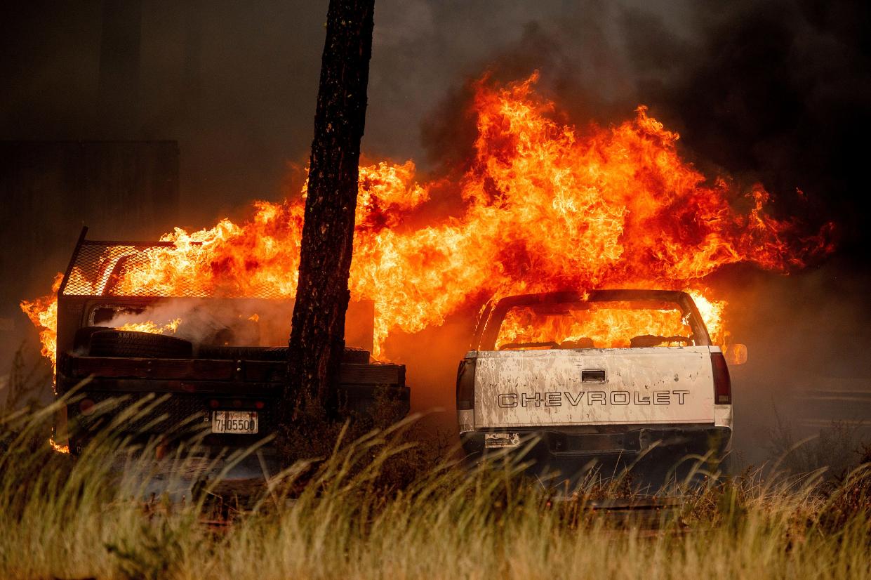Flames consume vehicles in a wrecking yard as the Dixie Fire burns in Chester, Calif. on Wednesday, Aug. 4, 2021. The region is under red flag fire warnings due to dry, windy conditions.