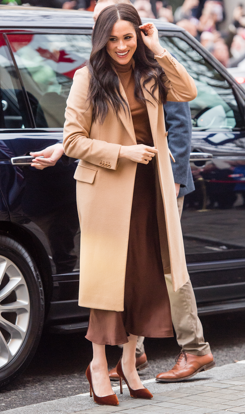 <p>The <a href="https://www.cosmopolitan.com/uk/fashion/celebrity/a30429860/meghan-markle-camel-coat/" rel="nofollow noopener" target="_blank" data-ylk="slk:camel coat;elm:context_link;itc:0;sec:content-canvas" class="link ">camel coat</a> is a royal staple and Meghan's Reiss style is utterly timeless. The Duchess wore the piece over a silky chocolate slip skirt, caramel jumper, complete with a pair of bronze velvet heels.</p>