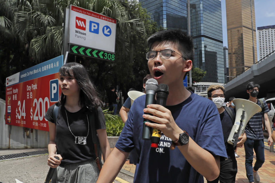 In this June 21, 2019, photo, pro-democracy activists Agnes Chow, left, and Joshua Wong march to police headquarters in Hong Kong. Demosisto, a pro-democracy group in Hong Kong posted on its social media accounts that well-known activist Joshua Wong had been pushed into a private car around 7:30 a.m. Friday, Aug. 30, 2019 and was taken to police headquarters. It later said another member, Agnes Chow, had been arrested as well. (AP Photo/Kin Cheung)