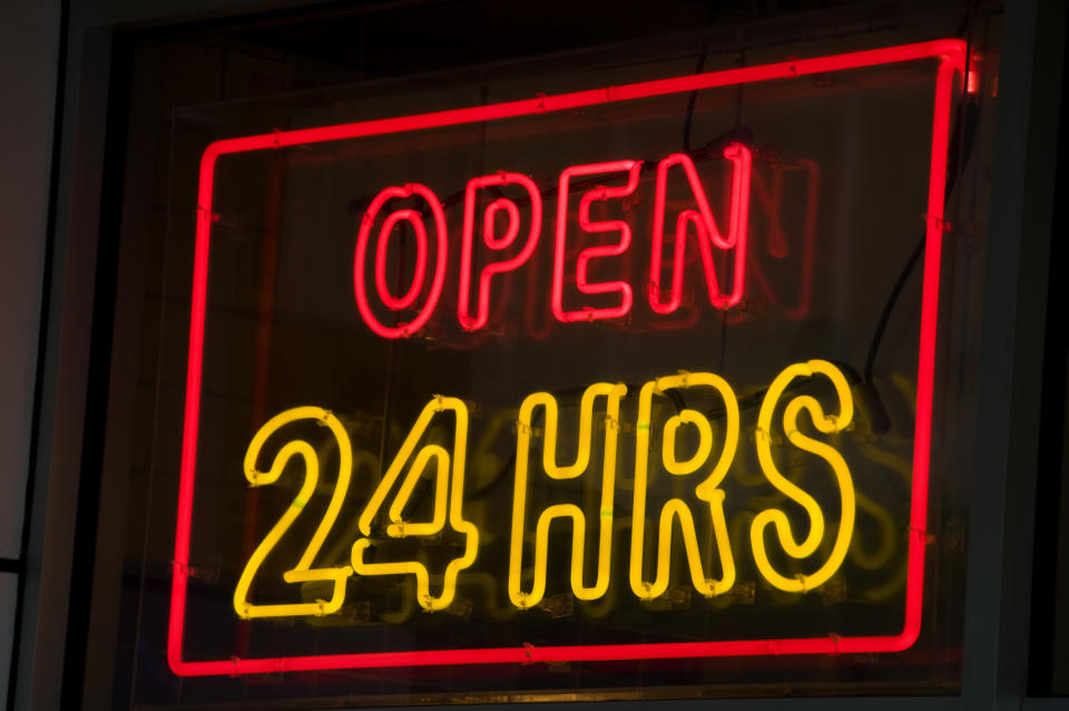 A neon 24-hour sign