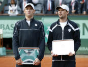 US Bob Bryan (R) and US Mike Bryan (L) pose with a trophy after losing to Belarus Max Mirnyi and Canada's Daniel Nestor during Men's Doubles final tennis match of the French Open tennis tournament at the Roland Garros stadium, on June 9, 2012 in Paris. AFP PHOTO / THOMAS COEXTHOMAS COEX/AFP/GettyImages