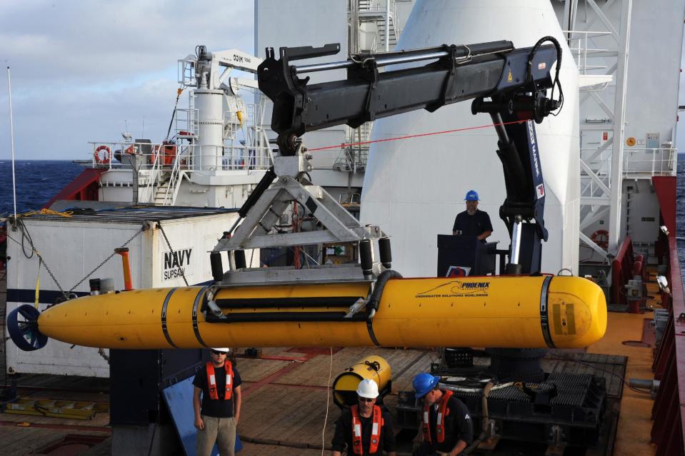 In a Monday, April 14, 2014 photo provided by the U.S. Navy, operators aboard the Australian defense vessel Ocean Shield move the U.S. Navy's Bluefin-21 autonomous underwater vehicle into position for deployment to search for the missing Malaysia Airlines Flight 370. On Tuesday, April 15, 2014, the U.S. Navy and search coordinators said that a built-in safety feature aborted what was supposed to have been a 16-hour mission to create a sonar map of the ocean floor after only six hours. (AP Photo/U.S. Navy, MC1 Peter D. Blair)