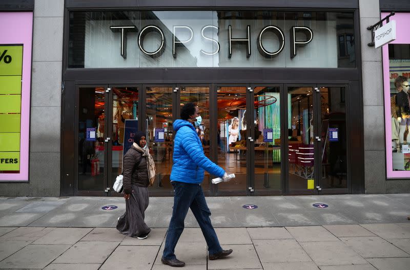 FILE PHOTO: People walk past an entrance to the Topshop store at the Oxford Street, in London