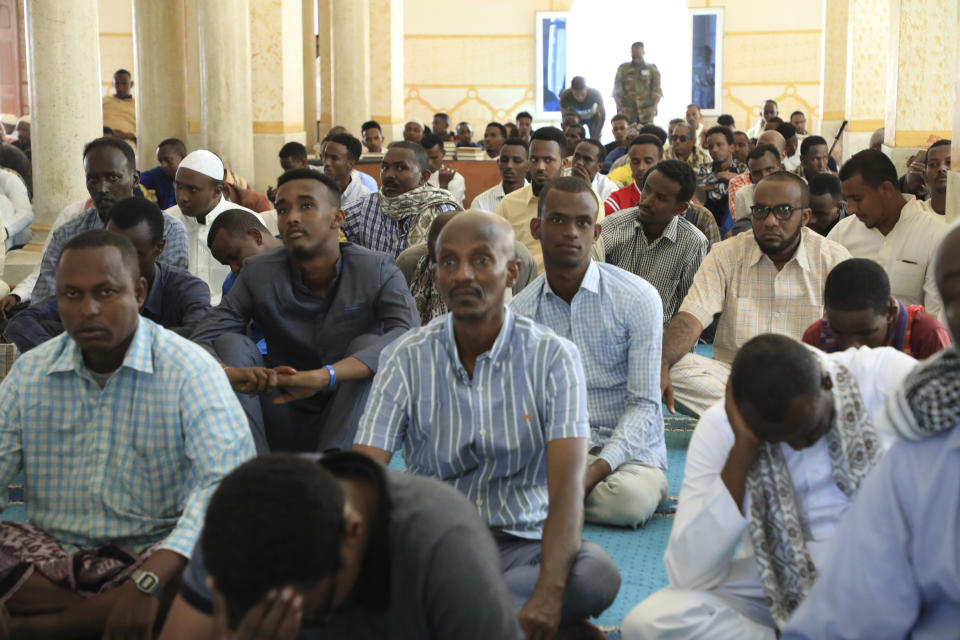 Somali men without facemasks wait for prayer at the Isbaheysiga Mosque in Mogadishu, Somalia on Friday Dec. 4, 2020. As richer countries race to distribute COVID-19 vaccines, Somalia remains the rare place where much of the population hasn't taken the coronavirus seriously. Some fear that’s proven to be deadlier than anyone knows. (AP Photo/Farah Abdi Warsameh)