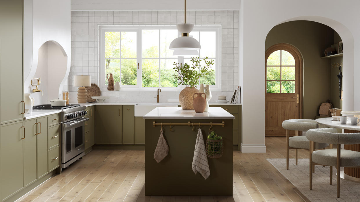  Olive green traditional kitchen with a central island unit. 