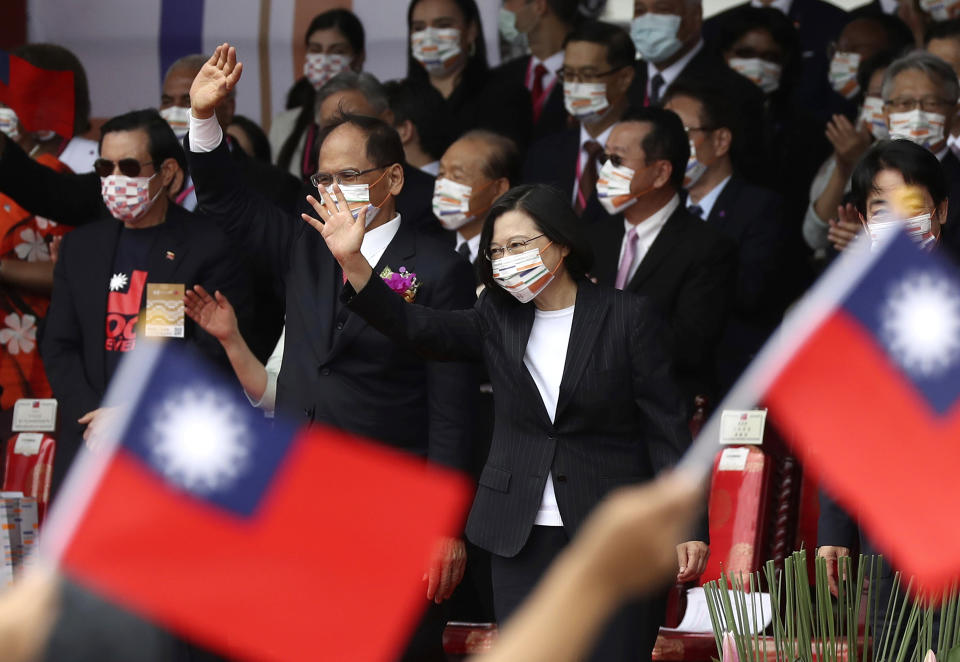 Taiwan's President Tsai Ing-wen, right, and Yu Shyi-kun, speaker of the Legislative Yuan, cheer with audience during National Day celebrations in front of the Presidential Building in Taipei, Taiwan, Saturday, Oct. 10, 2020. President Tsai said Saturday she has hopes for less tensions with China and in the region if Beijing will listen to Taipei’s concerns, alter its approach and restart dialogue with the self-ruled island democracy. (AP Photo/Chiang Ying-ying)