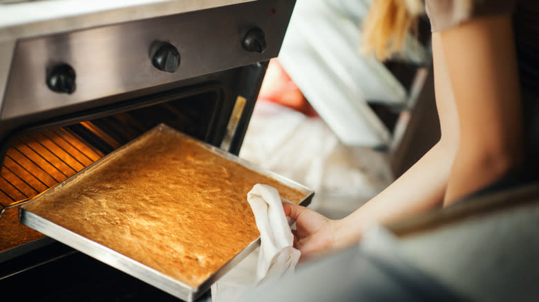 cake being removed from the oven