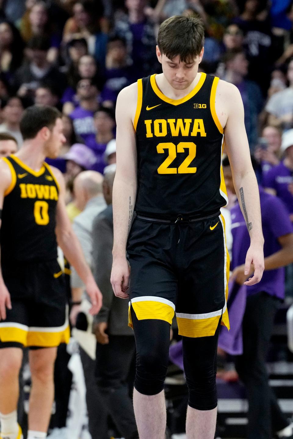 Iowa forward Patrick McCaffery walks on the court during the first half of an NCAA college basketball game against Northwestern in Evanston, Ill., Sunday, Feb. 19, 2023.
