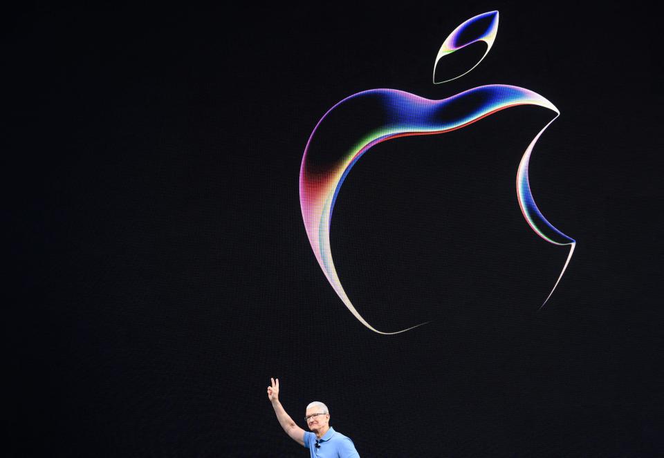 Apple CEO Tim Cook below the Apple logo.