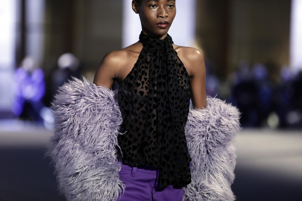 A model wears a creation by Alexandre Mattiussi for the Ami fall-winter 22/23 men's collection, in Paris, Wednesday, Jan. 19, 2022. (AP Photo/Lewis Joly)