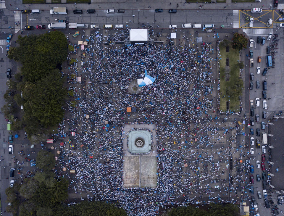 In this Sept. 2, 2018 photo, people gather at the Plaza de la Constitucion in Guatemala City at the end of an anti-abortion march. The march was in support of a new bill that expands the criminalization of abortion and could subject women who have miscarriages to prosecution. The proposed legislation has been approved twice by Congress and needs a third approval. (AP Photo/Santiago Billy)