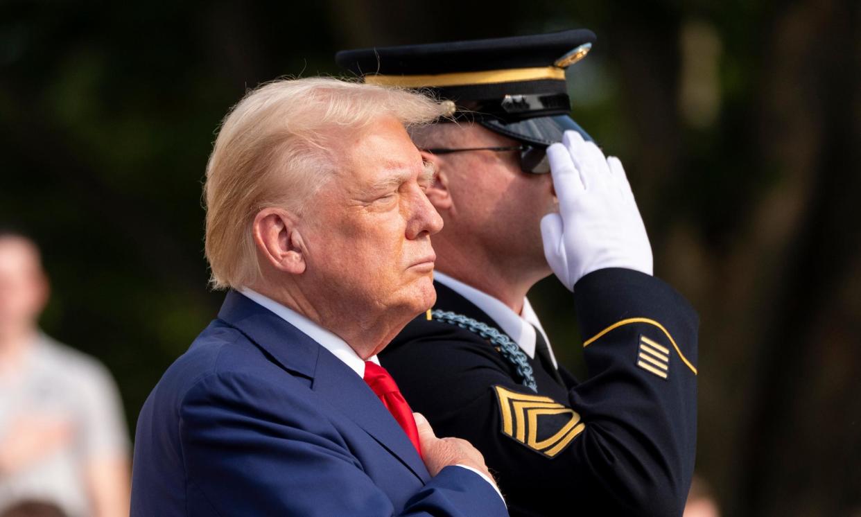 <span>Donald Trump at a wreath laying ceremony at Arlington National Cemetery on Monday.</span><span>Photograph: Alex Brandon/AP</span>