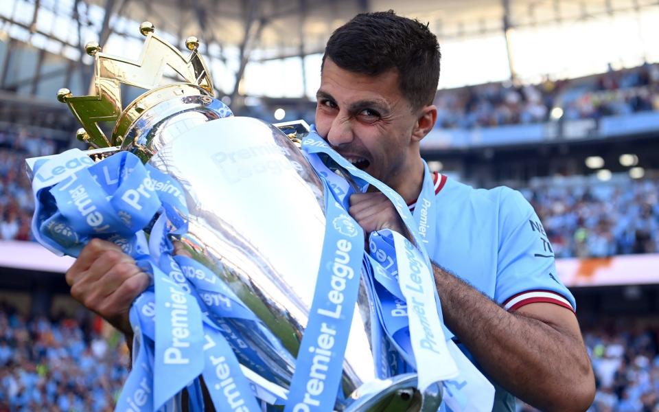 Ruben Dias of Manchester City celebrates with the Premier League trophy following the Premier League match between Manchester City and Chelsea FC at Etihad Stadium on May 21, 2023 in Manchester, England - Getty Images/Michael Regan