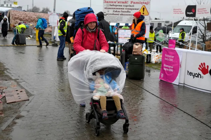 A woman with a child returns to Ukraine from the border crossing in Medyka, southeastern Poland,  on March 31, 2022.