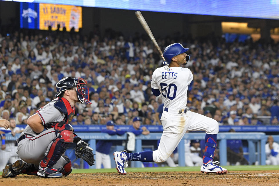 FILE - Los Angeles Dodgers' Mookie Betts watches his three-run home run next to Atlanta Braves catcher Sean Murphy during the fifth inning of a baseball game Aug. 31, 2023, in Los Angeles. Betts has put himself into the NL MVP discussion with a stellar second half that has propelled the Dodgers to the top of the NL West. (AP Photo/Mark J. Terrill, File)