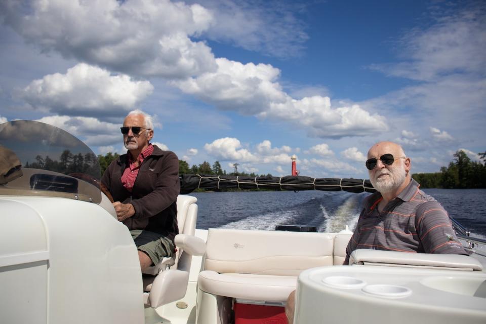 Don Bishop (left) and Peter Heinermann (right) cruise along Golden Lake in July 2023. They're part of a plan to restore the lake's walleye population — which has been decimated by rainbow smelt — to levels not seen in ages.