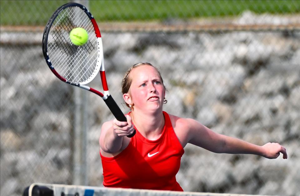 Edgewood’s Sophia Kapperman hits a forehand volley during her No. 1 doubles match during the tennis match at Bloomington North on Tuesday, April 16, 2024.